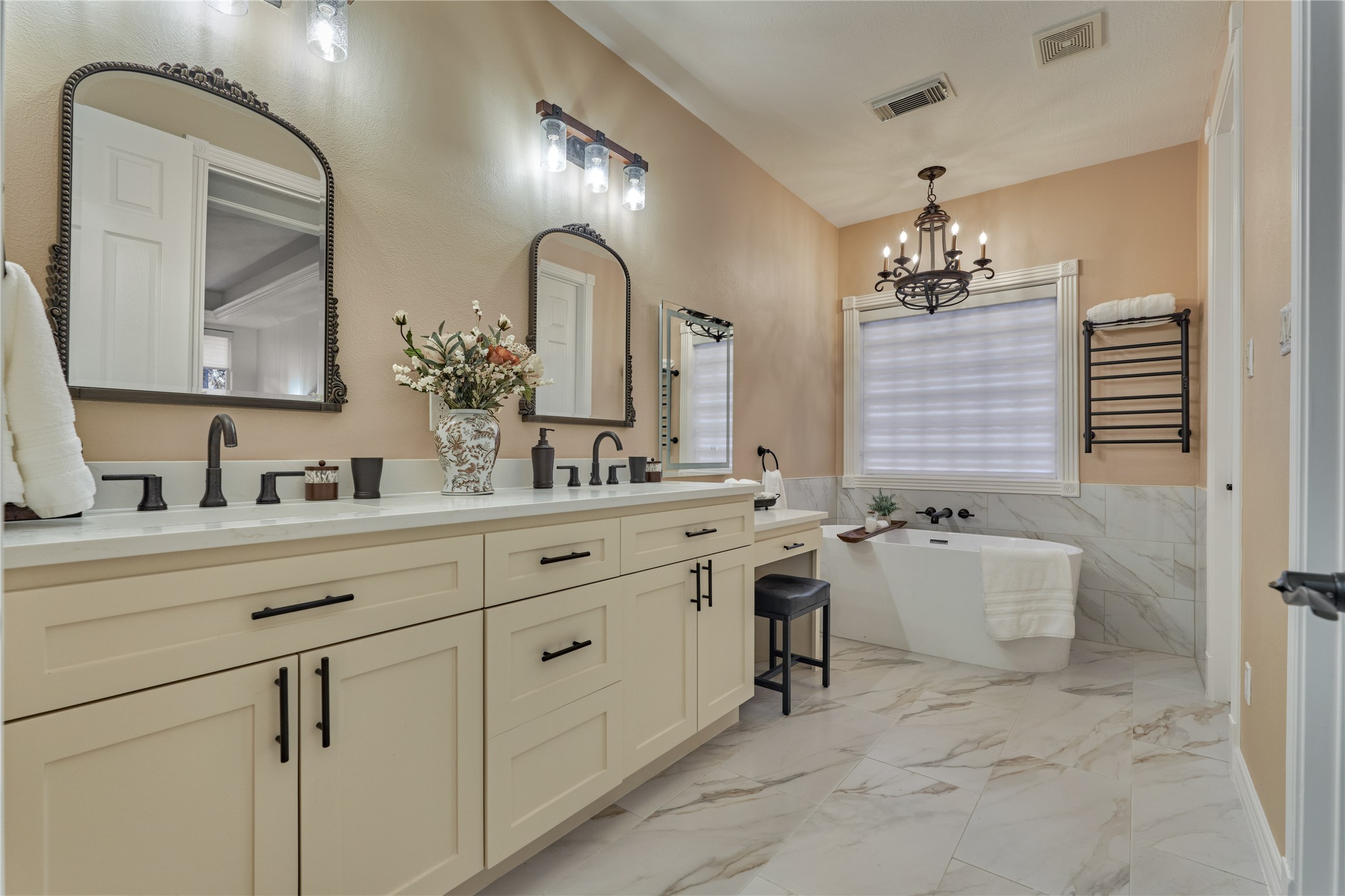 203 Monterrey Road East Montgomery, TX 77356 - Photo 25 of 50 The elegant spa-like ensuite bath will be your place of refuge with it's neutral color palate and lux amenities. Take note of the new towel warmer to the right of the soaking tub.