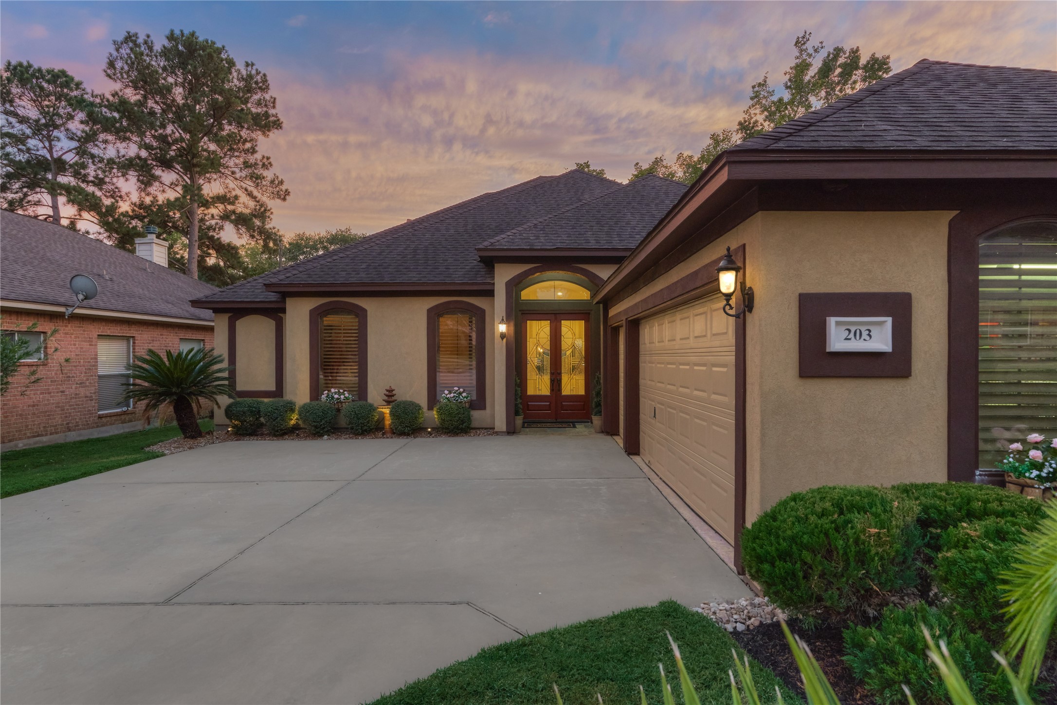 203 Monterrey Road East Montgomery, TX 77356 - Photo 5 of 50 The oversized 2-car garage features epoxy flooring, A/C, workbench, charger for EV and a golf cart garage. There is also outdoor access to and from the side yard.