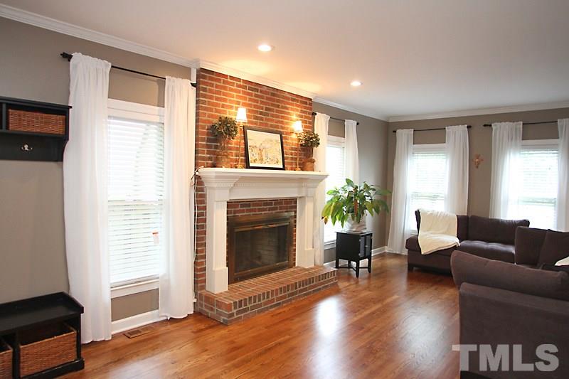 5116 Celbridge Place Raleigh, NC 27613 - Photo 2 of 15 a living room with furniture and a fireplace