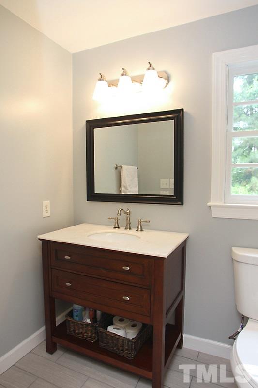 5116 Celbridge Place Raleigh, NC 27613 - Photo 11 of 15 a bathroom with a toilet sink and mirror