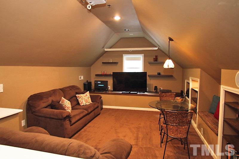 5116 Celbridge Place Raleigh, NC 27613 - Photo 12 of 15 a living room with furniture and a flat screen tv