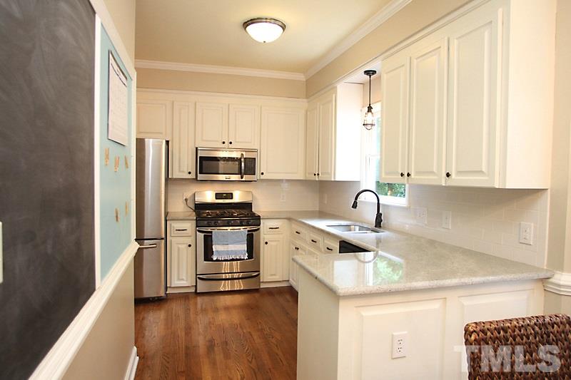 5116 Celbridge Place Raleigh, NC 27613 - Photo 5 of 15 a kitchen with stainless steel appliances granite countertop a stove a sink dishwasher and a refrigerator