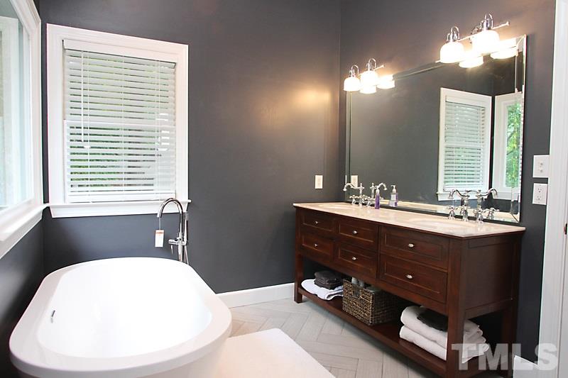 5116 Celbridge Place Raleigh, NC 27613 - Photo 7 of 15 a bathroom with a double vanity sink and a mirror