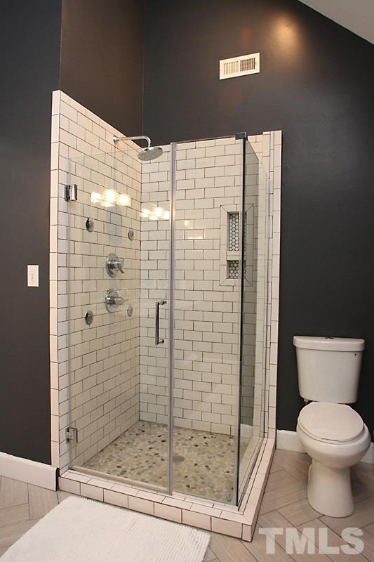 5116 Celbridge Place Raleigh, NC 27613 - Photo 8 of 15 a bathroom with a shower and toilet