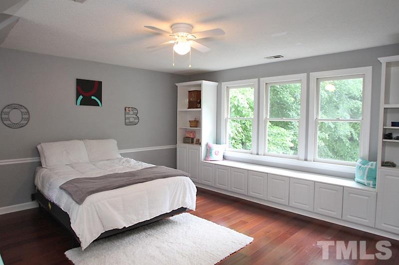5116 Celbridge Place Raleigh, NC 27613 - Photo 9 of 15 a bedroom with a large bed and a window