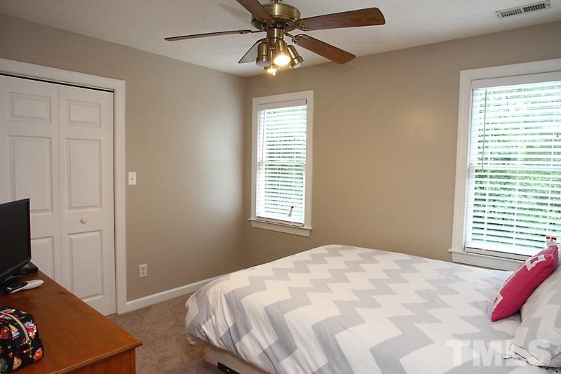 5116 Celbridge Place Raleigh, NC 27613 - Photo 10 of 15 a bedroom with a bed and a window