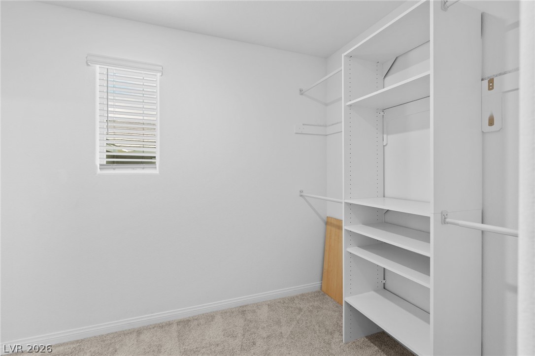 12367 Indigo Montage Road, Unit 3 Las Vegas, NV 89183 - Photo 13 of 33 This spacious walk-in closet features ample storage and natural light.