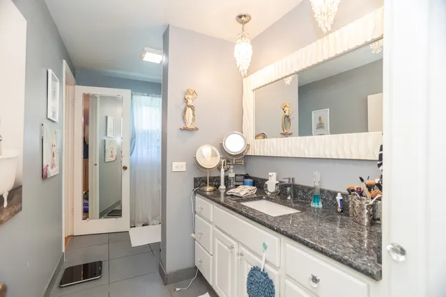 a bathroom with a sink mirror vanity and toilet