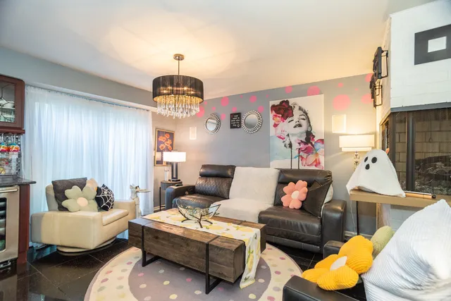 a living room with furniture and a chandelier