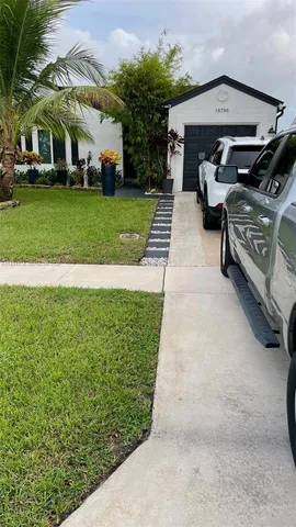 a view of a patio with table and chairs under an umbrella