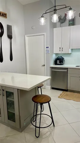 a kitchen with stainless steel appliances a stove a sink and a refrigerator