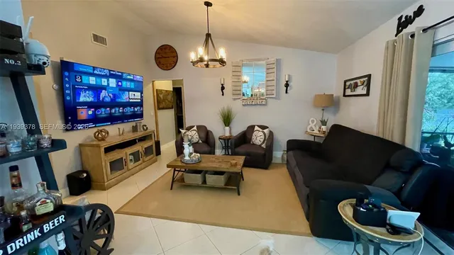 a living room with furniture flat screen tv and a fireplace