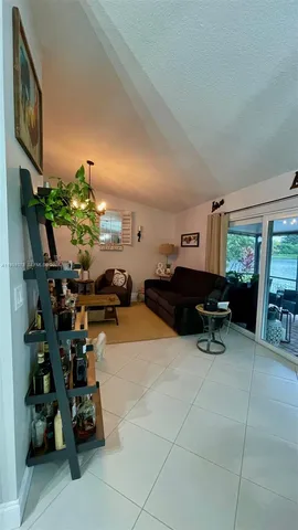 a gym area with furniture and a potted plant