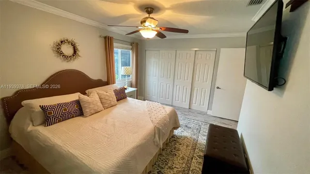 a bedroom with a bed and a flat screen tv