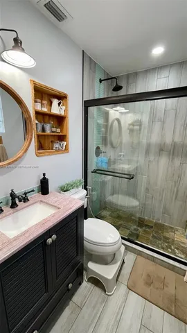 a bathroom with a sink toilet and shower
