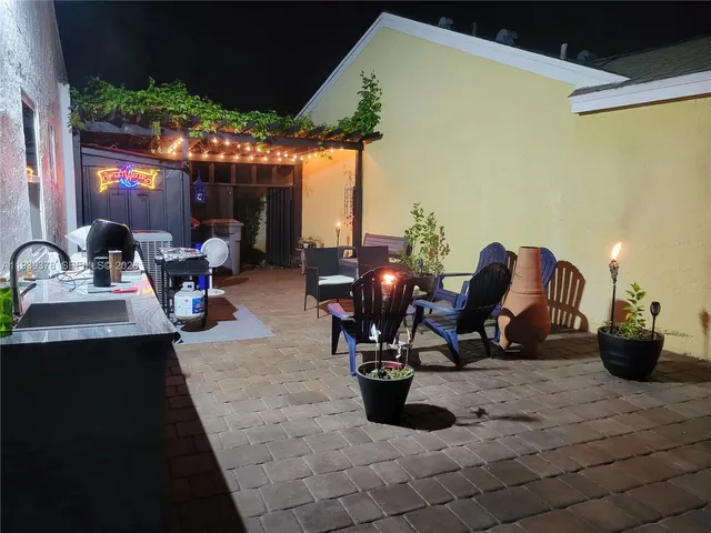 a view of a patio with dining table and chairs with the patio
