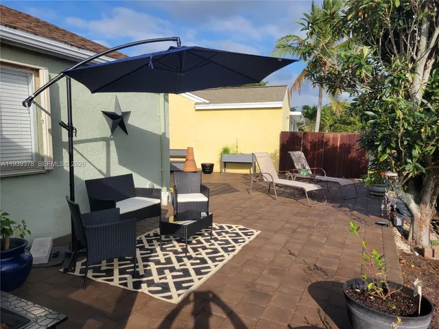 a view of a chairs and table in the patio