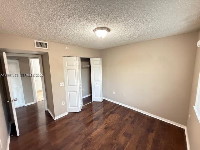 4167 Haverhill Road, Unit 1113 West Palm Beach, FL 33417 - Photo 15 of 19 an empty room with wooden floor and windows