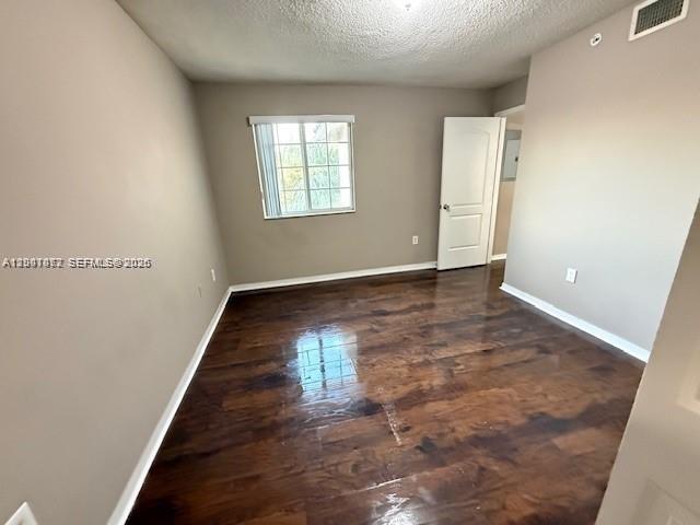 4167 Haverhill Road, Unit 1113 West Palm Beach, FL 33417 - Photo 18 of 19 an empty room with wooden floor and windows