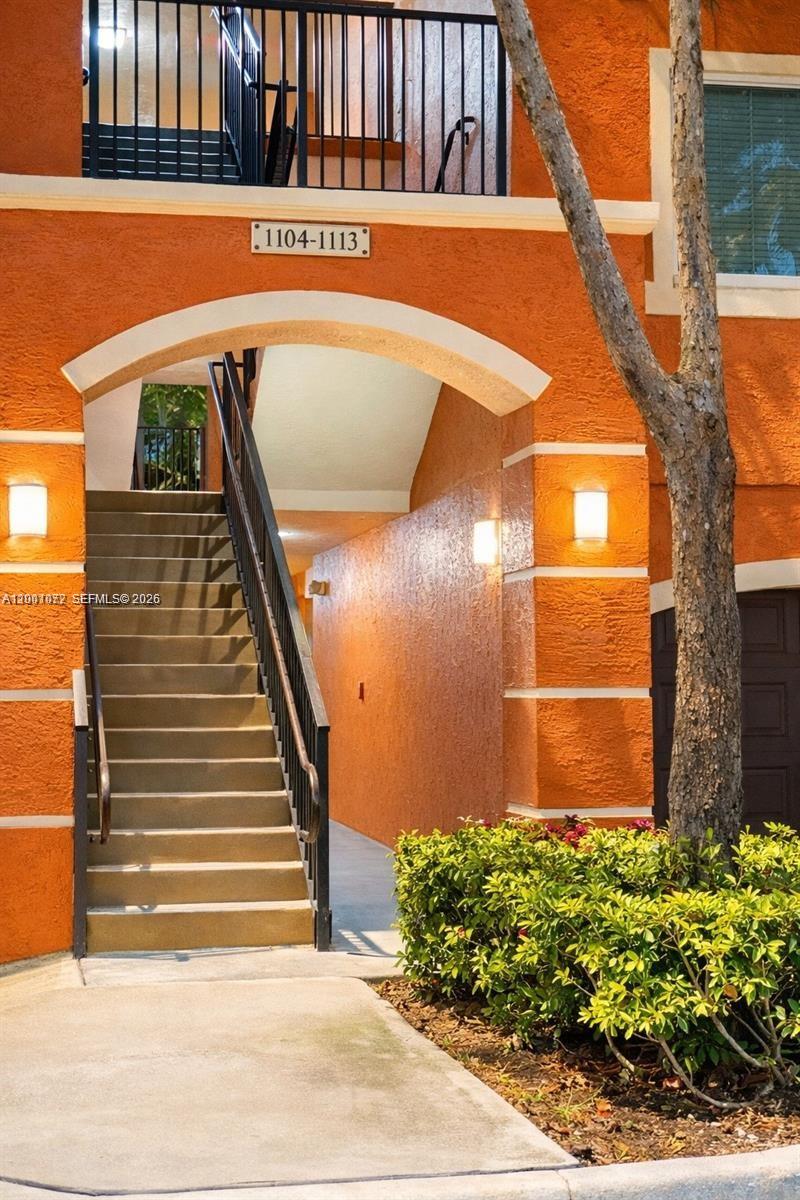 4167 Haverhill Road, Unit 1113 West Palm Beach, FL 33417 - Photo 2 of 19 a view of building with wooden stairs