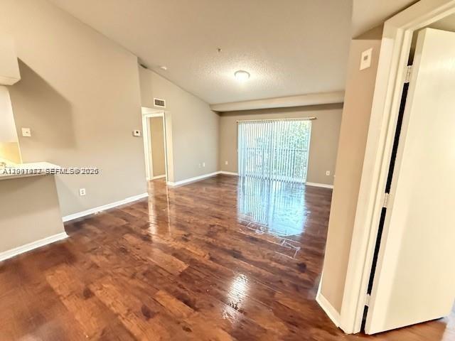 4167 Haverhill Road, Unit 1113 West Palm Beach, FL 33417 - Photo 4 of 19 a view of empty room with wooden floor and fan