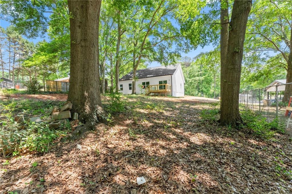 43 Anderson Street Jefferson, GA 30549 - Photo 39 of 45 a view of a house with a tree in the forest