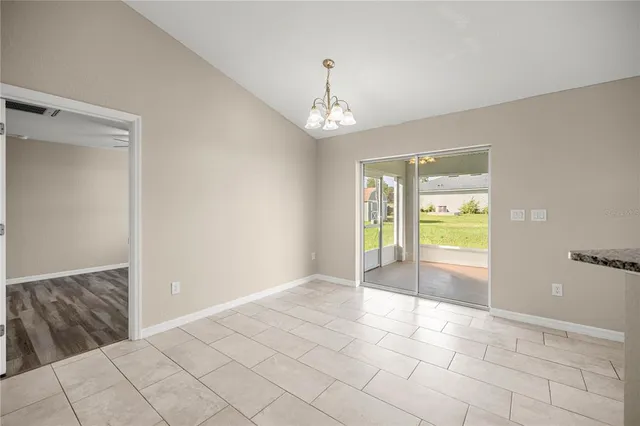 a view of an empty room with window and cabinet
