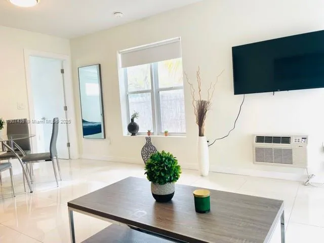 a view of living room with furniture and potted plant