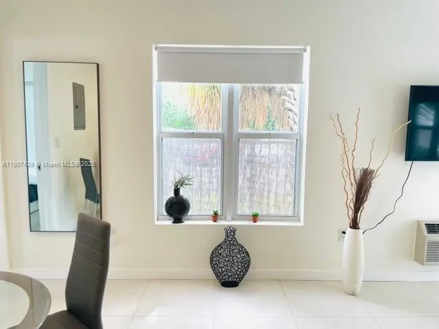 a bathroom with a tub and a large window