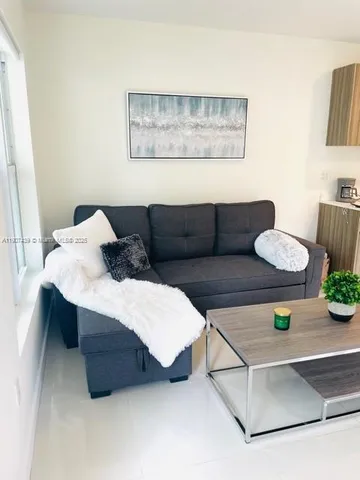 a bedroom with a bed and painting on the wall