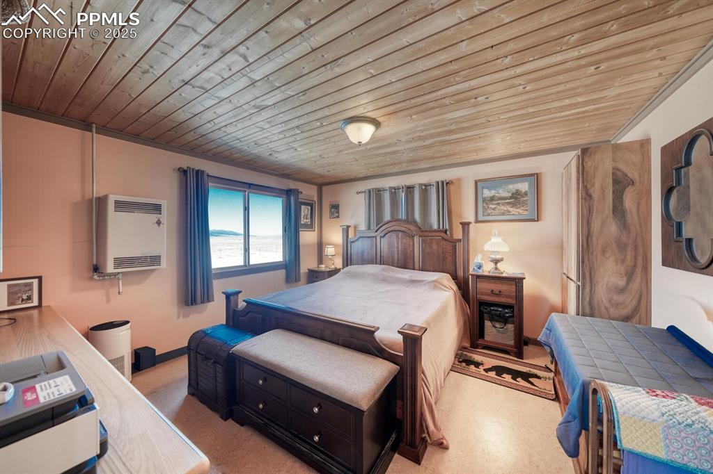 565 Pass Peak Road Westcliffe, CO 81252 - Photo 12 of 50 a bedroom with furniture and a window