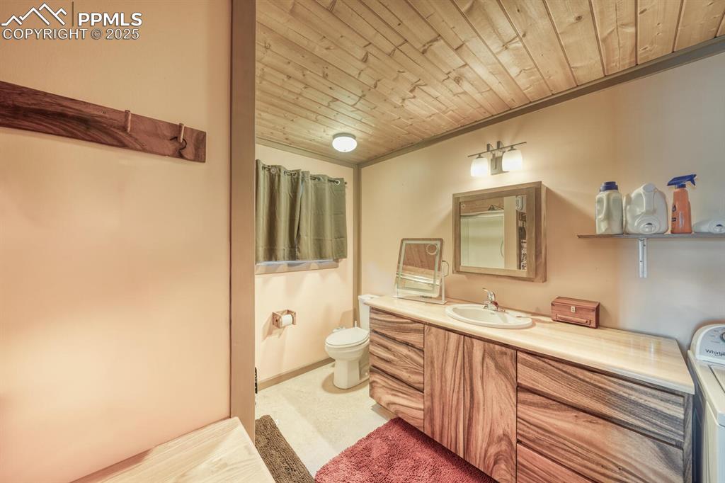 565 Pass Peak Road Westcliffe, CO 81252 - Photo 16 of 50 a bathroom with a sink a toilet and shower