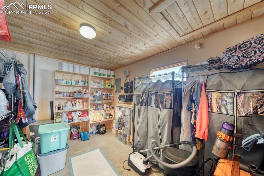 565 Pass Peak Road Westcliffe, CO 81252 - Photo 19 of 50 a view of walk in closet with clothes and shoes
