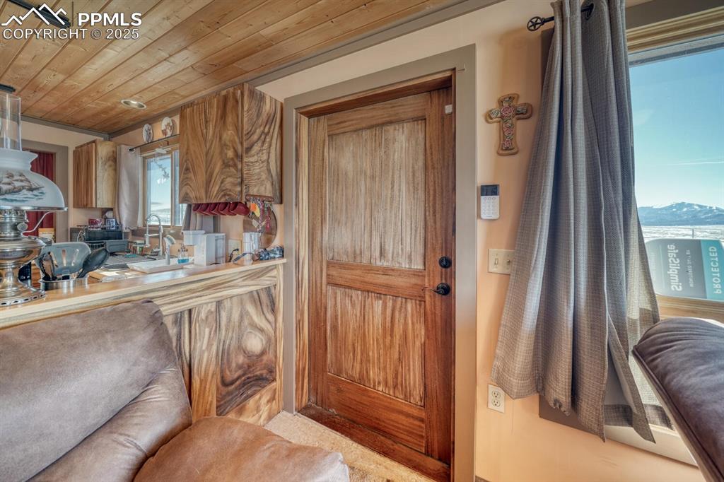 565 Pass Peak Road Westcliffe, CO 81252 - Photo 2 of 50 a view of a hallway with furniture and a window