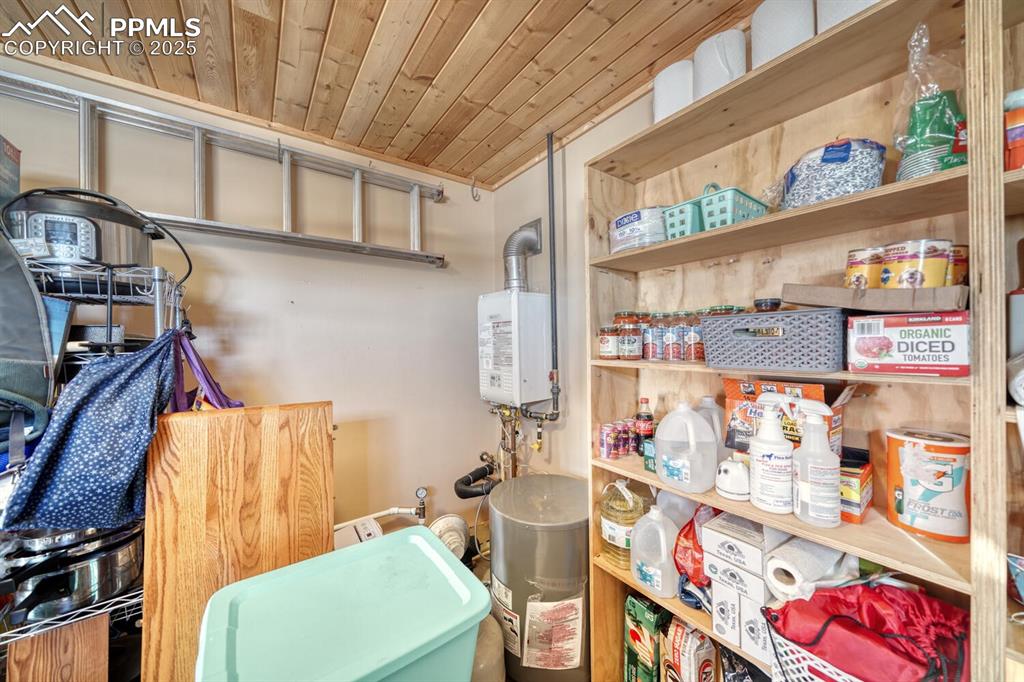 565 Pass Peak Road Westcliffe, CO 81252 - Photo 36 of 50 a utility room with lots of clutter and cabinets