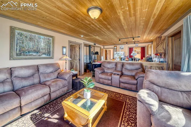 a living room with furniture and a chandelier