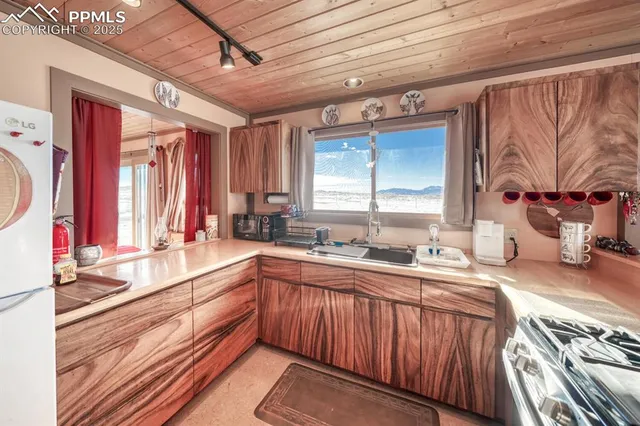 a kitchen with stainless steel appliances granite countertop a sink and wooden cabinets