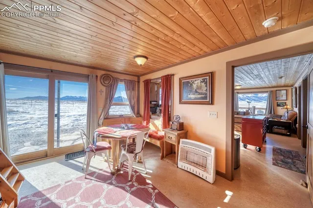 a outdoor space with lots of tables a large window and furniture