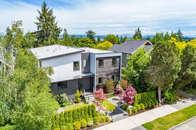 a aerial view of a house with a yard and sitting area