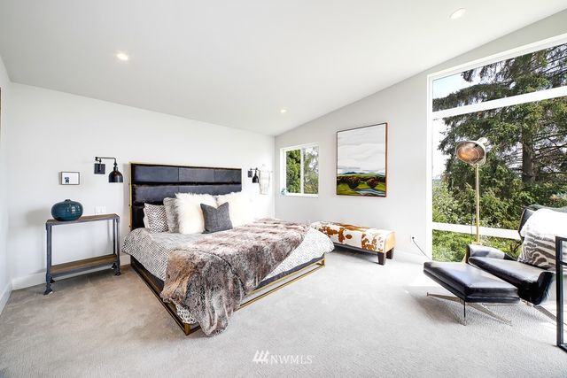 a bathroom with a double vanity sink mirror and bathtub