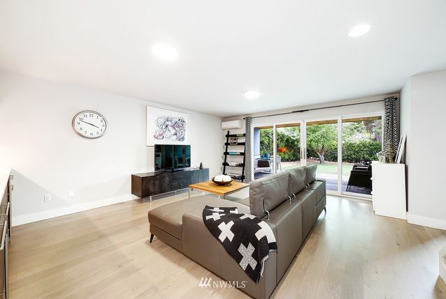 a view of swimming pool with lounge chairs in patio