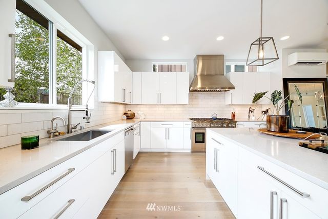 a living room with furniture a flat screen tv and a large window