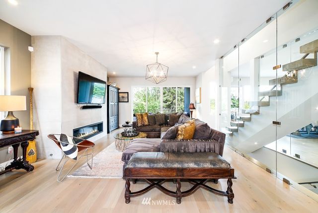 a living room with lots of furniture and a chandelier