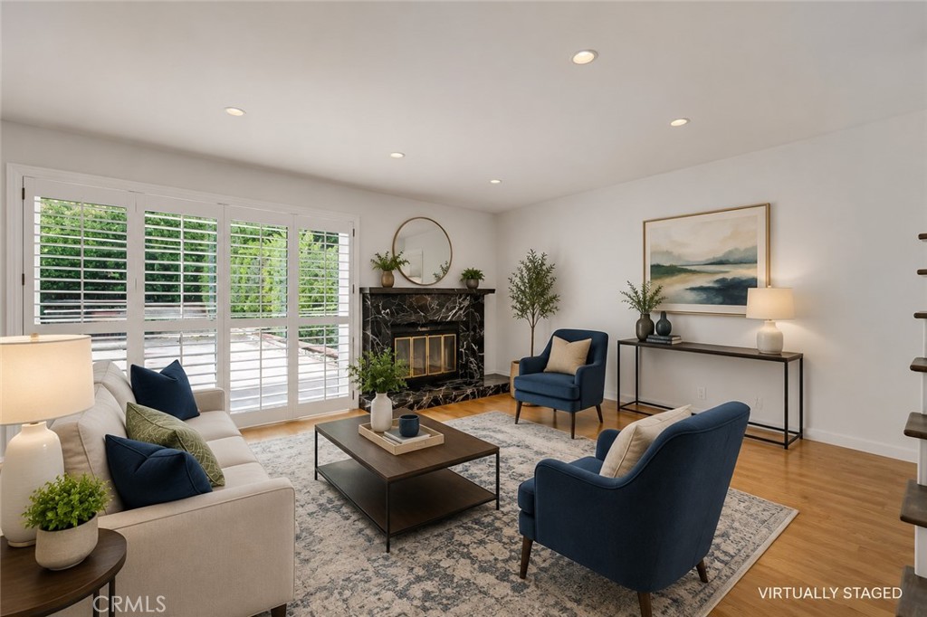 19451 Eagle Ridge Lane Porter Ranch, CA 91326 - Photo 19 of 59 a living room with fireplace furniture and a large window