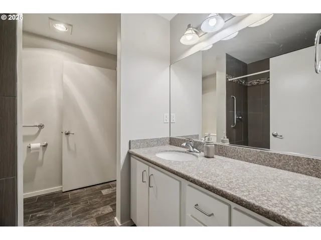 a bathroom with a granite countertop sink and a mirror