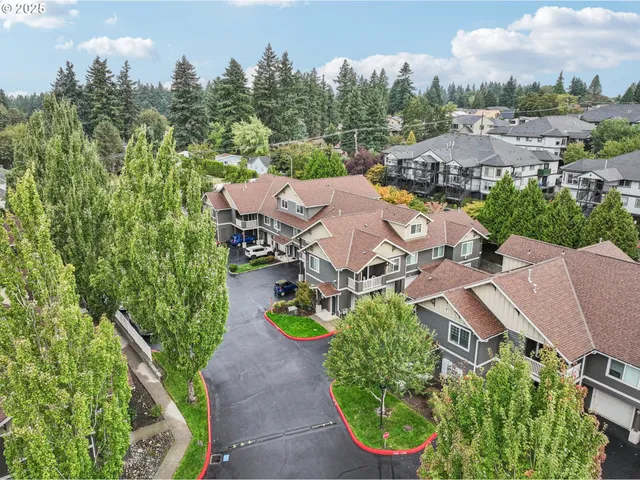 an aerial view of residential house with outdoor space and trees all around