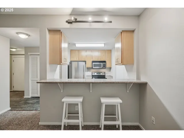 a kitchen with cabinets and wooden floor