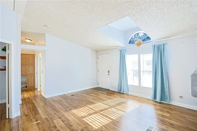 a view of a bedroom and wooden floor