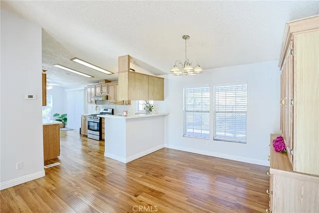 a view of a kitchen and dining room with wooden floor