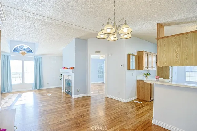 a view of a kitchen and a chandelier wooden floor
